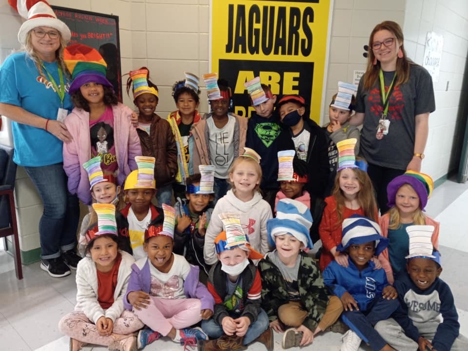 Group of students and teachers wearing  homemade Dr. Suess hats
