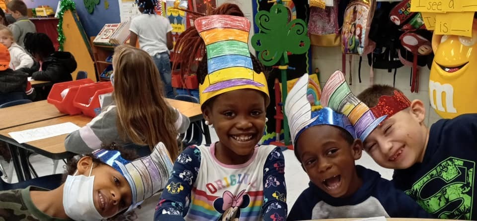 Smiling students pose for photo during Read Across America event