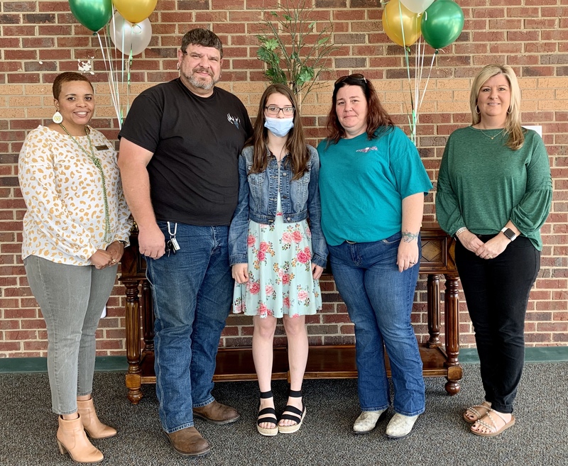 REACH Scholar Marley S. (center), pictured with her family and Dr. Shawn Benefield (left) and Rebecca Baldree (right)