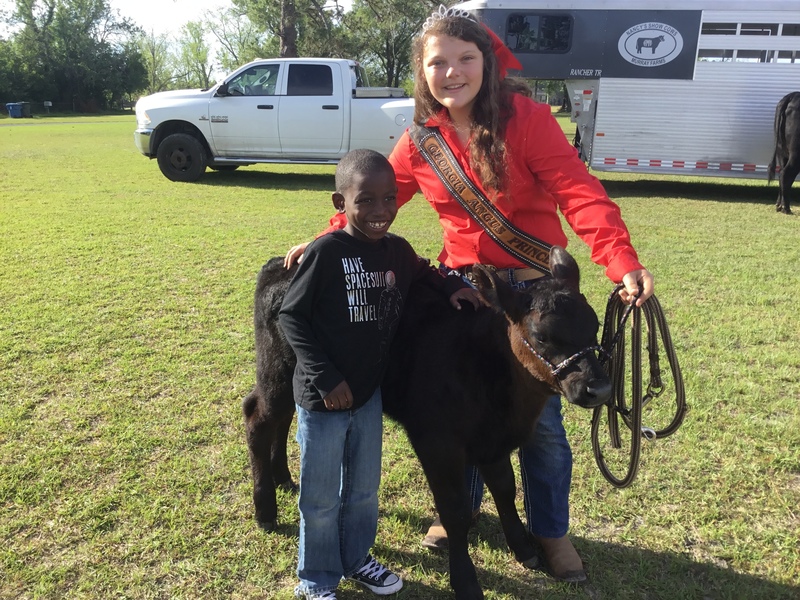 Student poses with calf